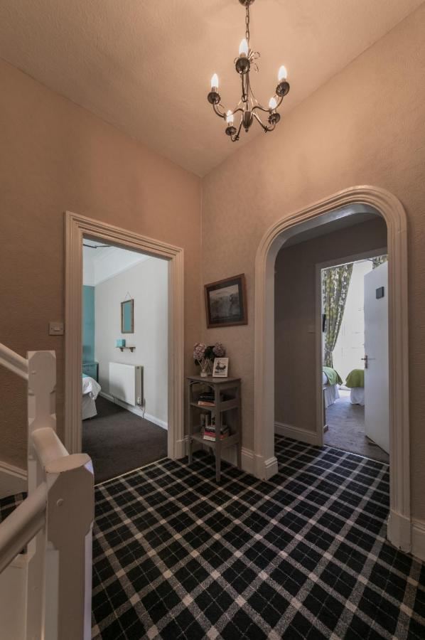 Landing with chequered runner leading to guest rooms