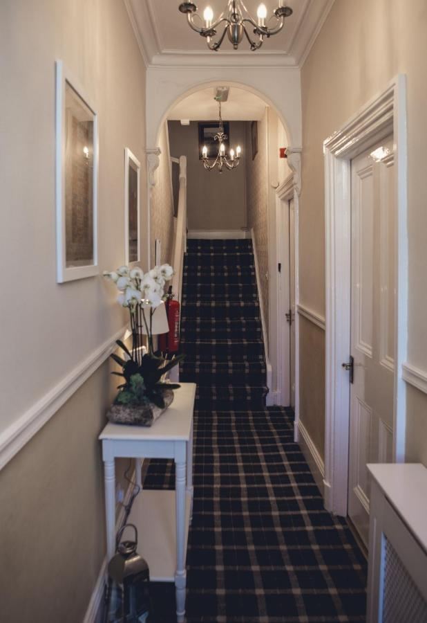 Carpeted staircase and hallway inside the guest house