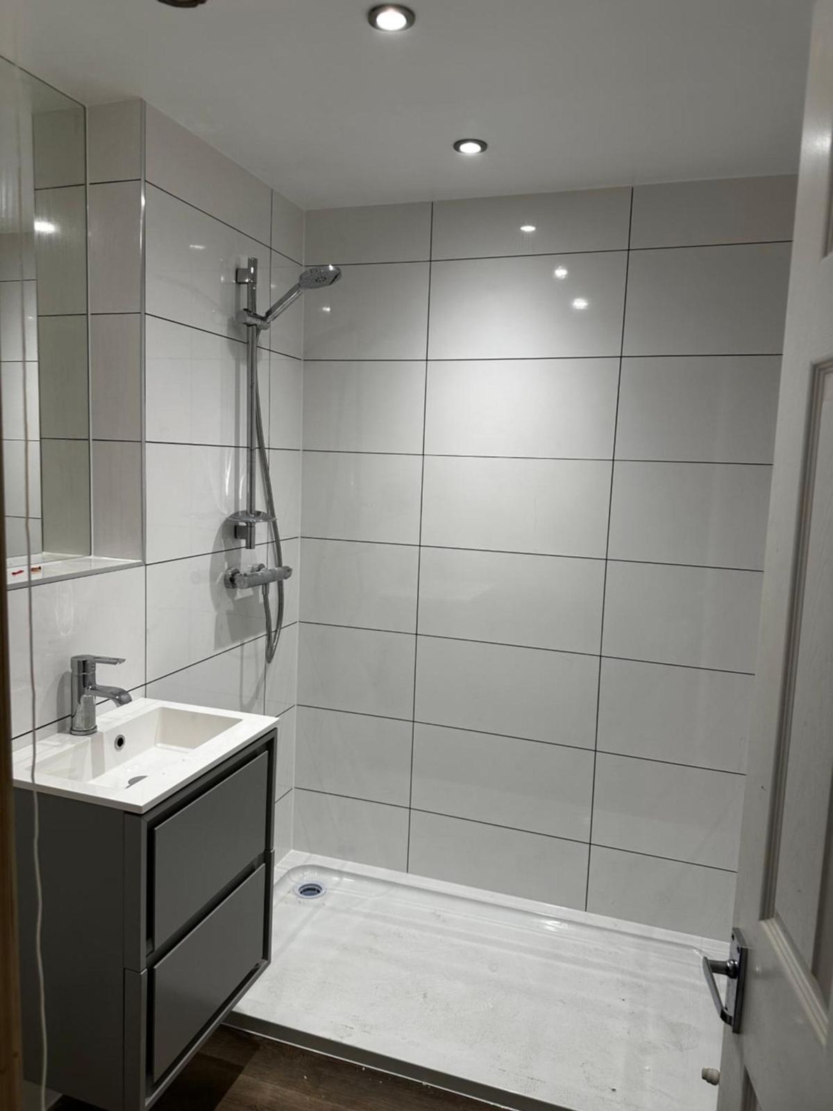 Modern walk-in shower room with glass screen